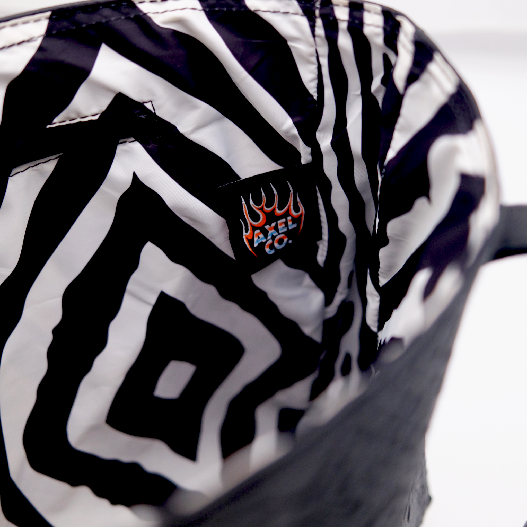 Zebra-patterned bag with a Axel Co logo lined inside the leather tote bag