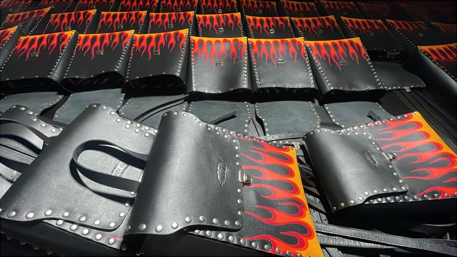 Axel Co backpacks being produced. Leather and studs and flames everywhere! Becky Goebel's design!