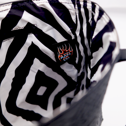 Zebra-patterned bag with a Axel Co logo lined inside the leather tote bag