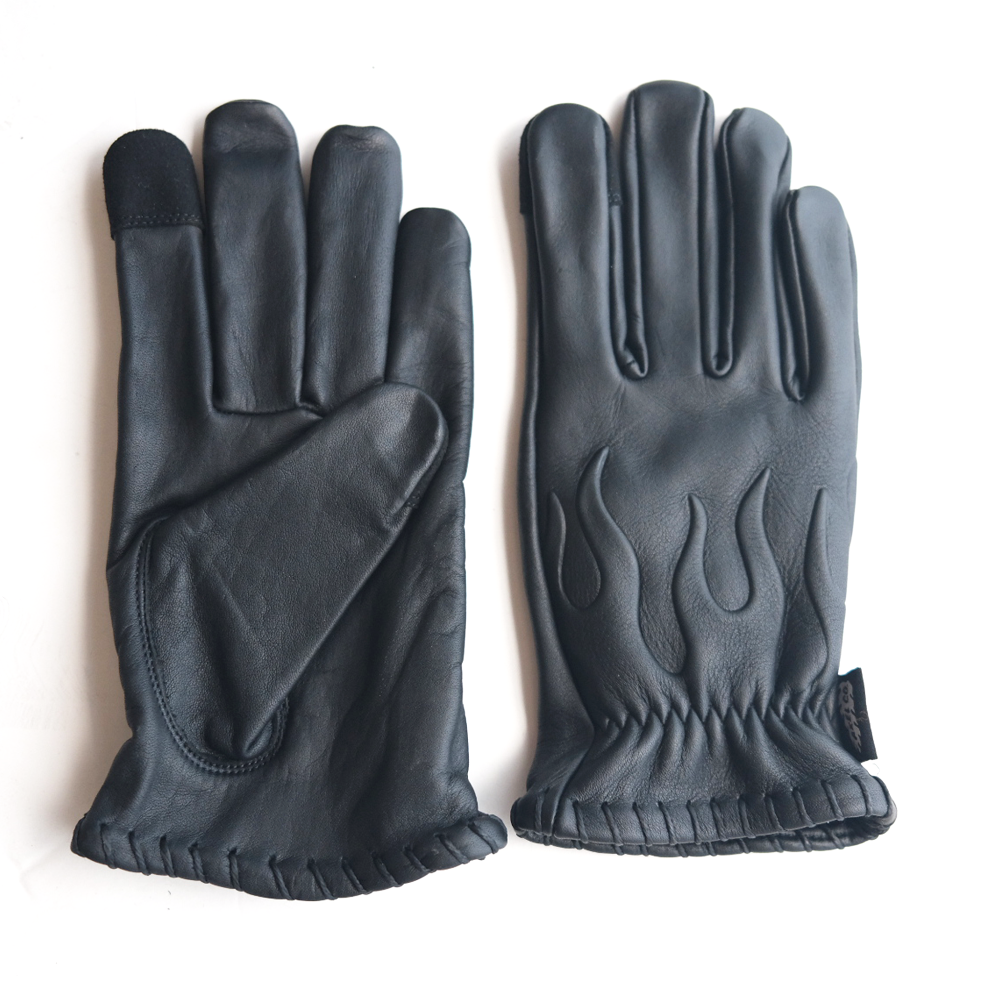 Pair of black motorcycle leather gloves with flame design on a white background